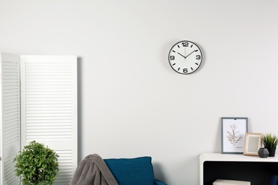 Room interior with clock on wall. Time management