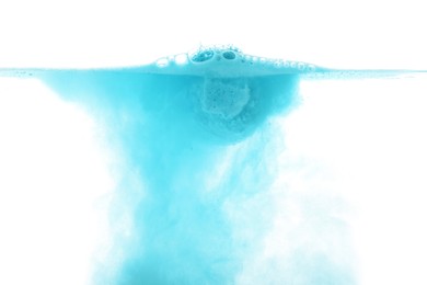 Light blue bath bomb in water on white background