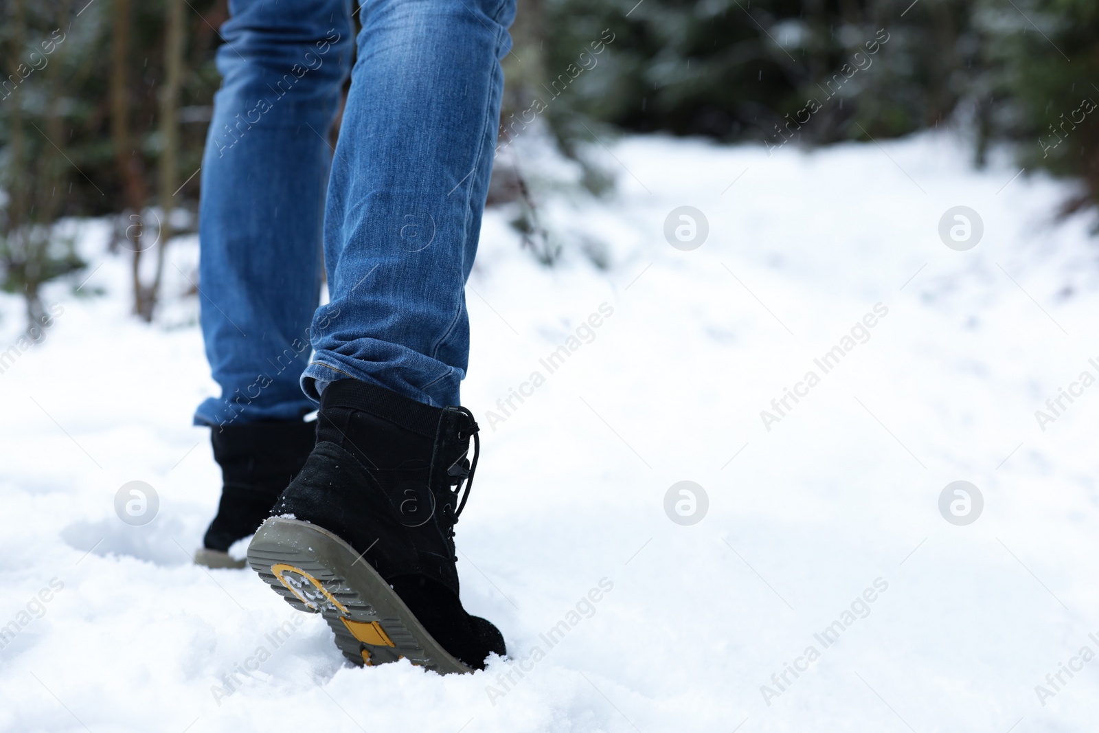 Photo of Woman walking outdoors on snowy day, closeup with space for text. Winter vacation