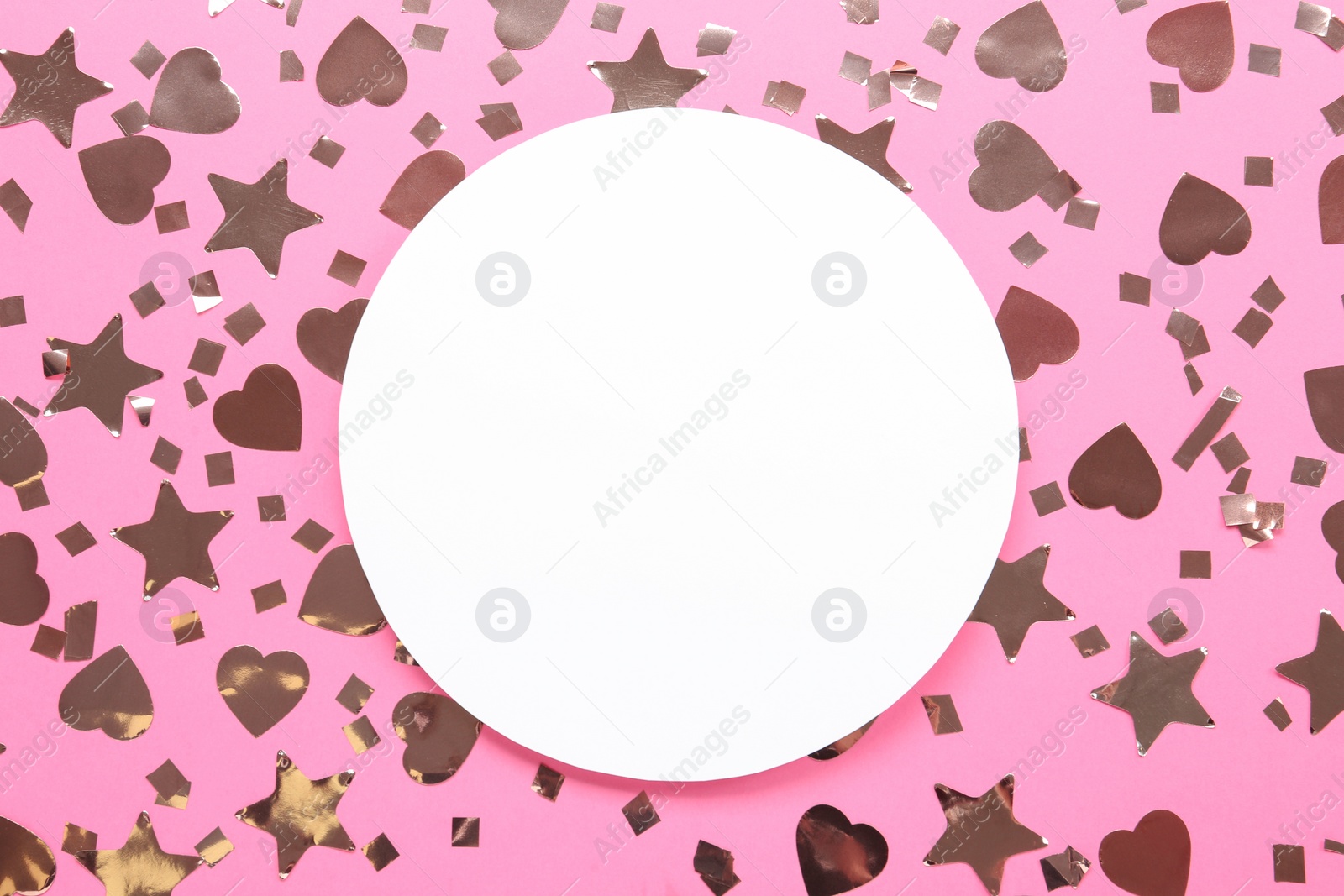 Photo of Blank card and shiny confetti on pink background, flat lay. Space for text