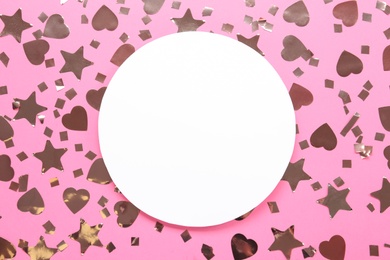 Blank card and shiny confetti on pink background, flat lay. Space for text