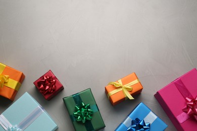 Photo of Many colorful gift boxes on light grey table, flat lay. Space for text