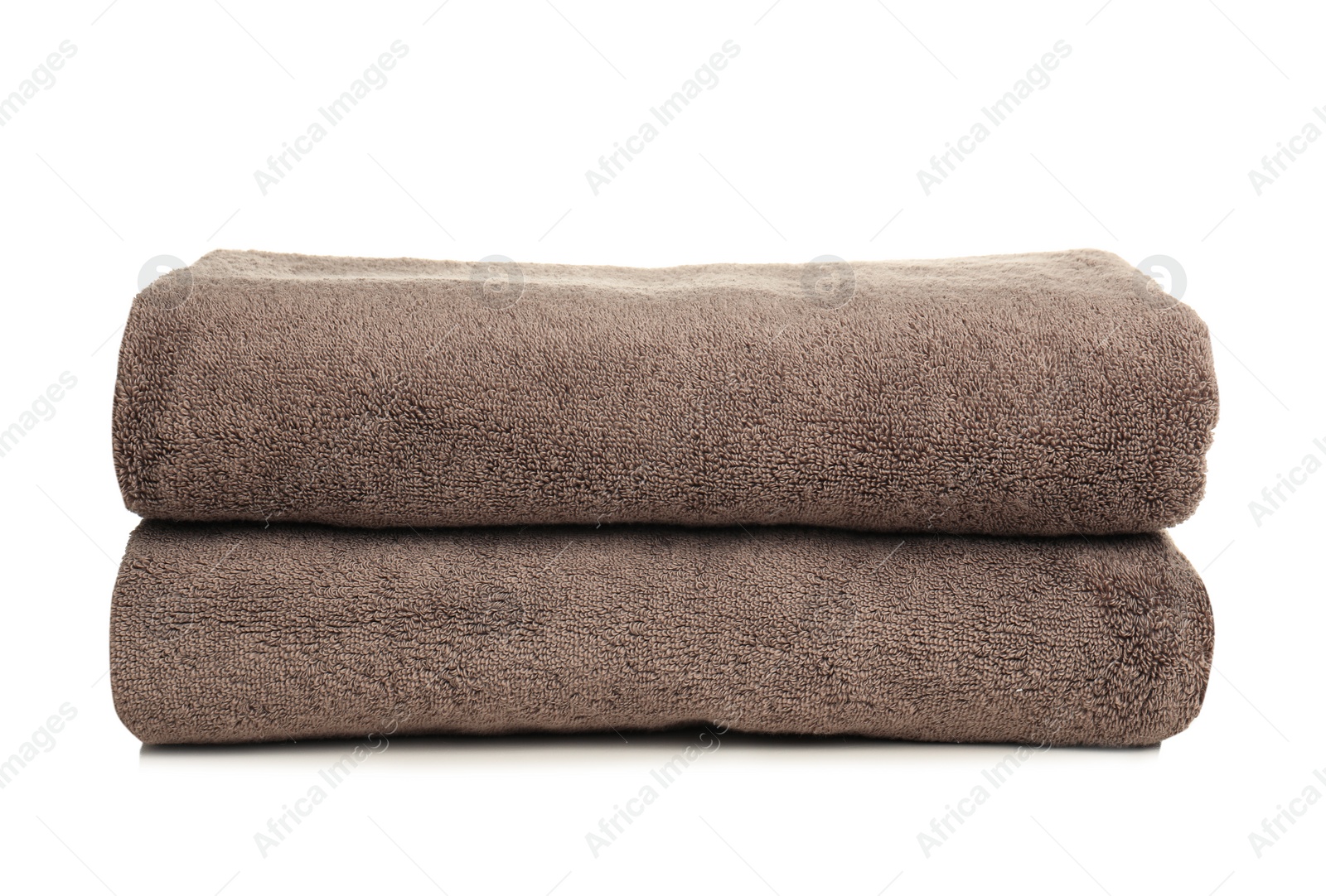 Photo of Folded soft terry towels on white background