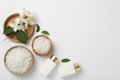 Photo of Flat lay composition with beautiful jasmine flowers, sea salt and skin care products on white background, space for text
