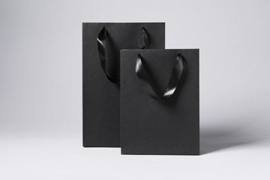 Black paper bags on light grey background