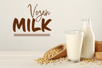 Image of Fresh vegan soy milk and grains on white wooden table