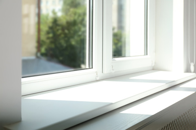 Photo of Closeup view of window with empty white sill