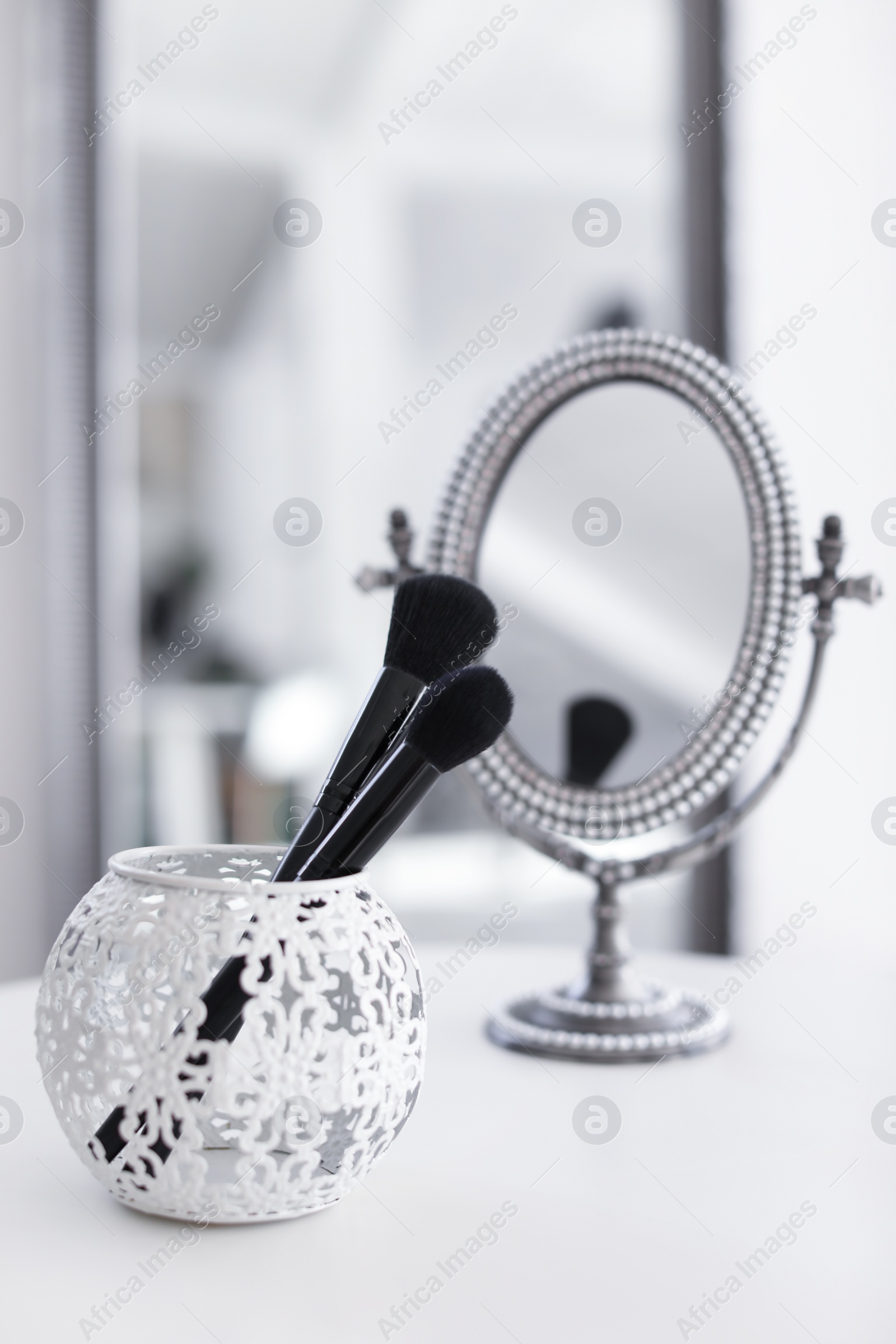 Photo of Holder with makeup brushes on table