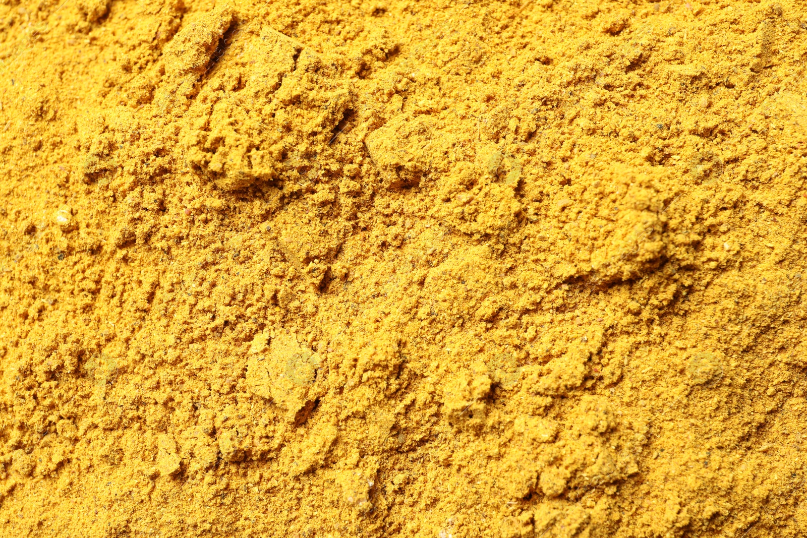 Photo of Dry curry powder as background, top view