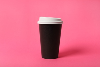 Photo of Takeaway paper coffee cup on pink background