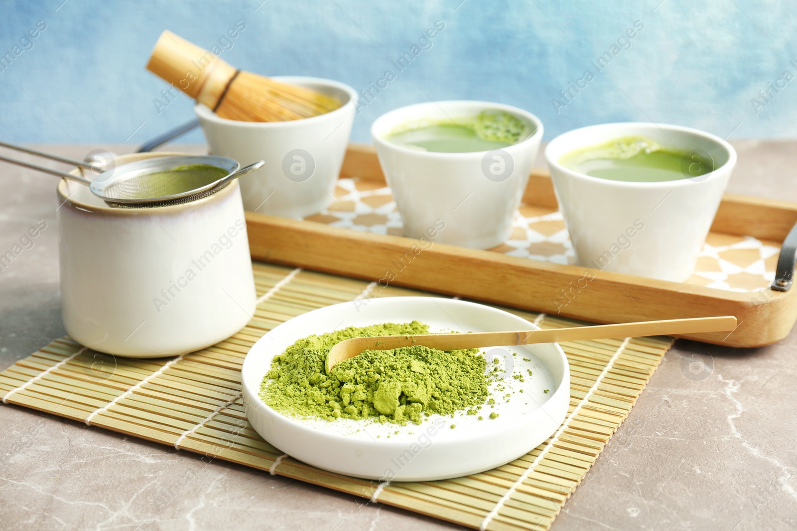 Photo of Plate with powdered matcha tea and chashaku on table