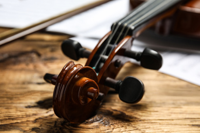 Classic violin on wooden background, closeup view