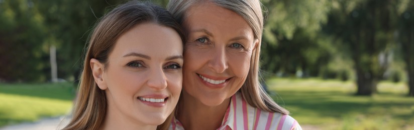 Image of Happy mother and daughter outdoors, banner design