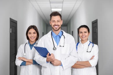 Team of professional doctors in clinic hallway