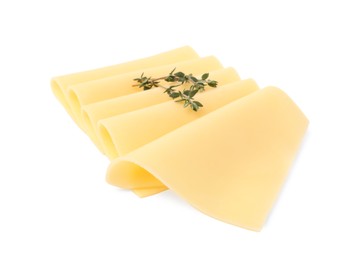 Photo of Slices of tasty fresh cheese and thyme isolated on white