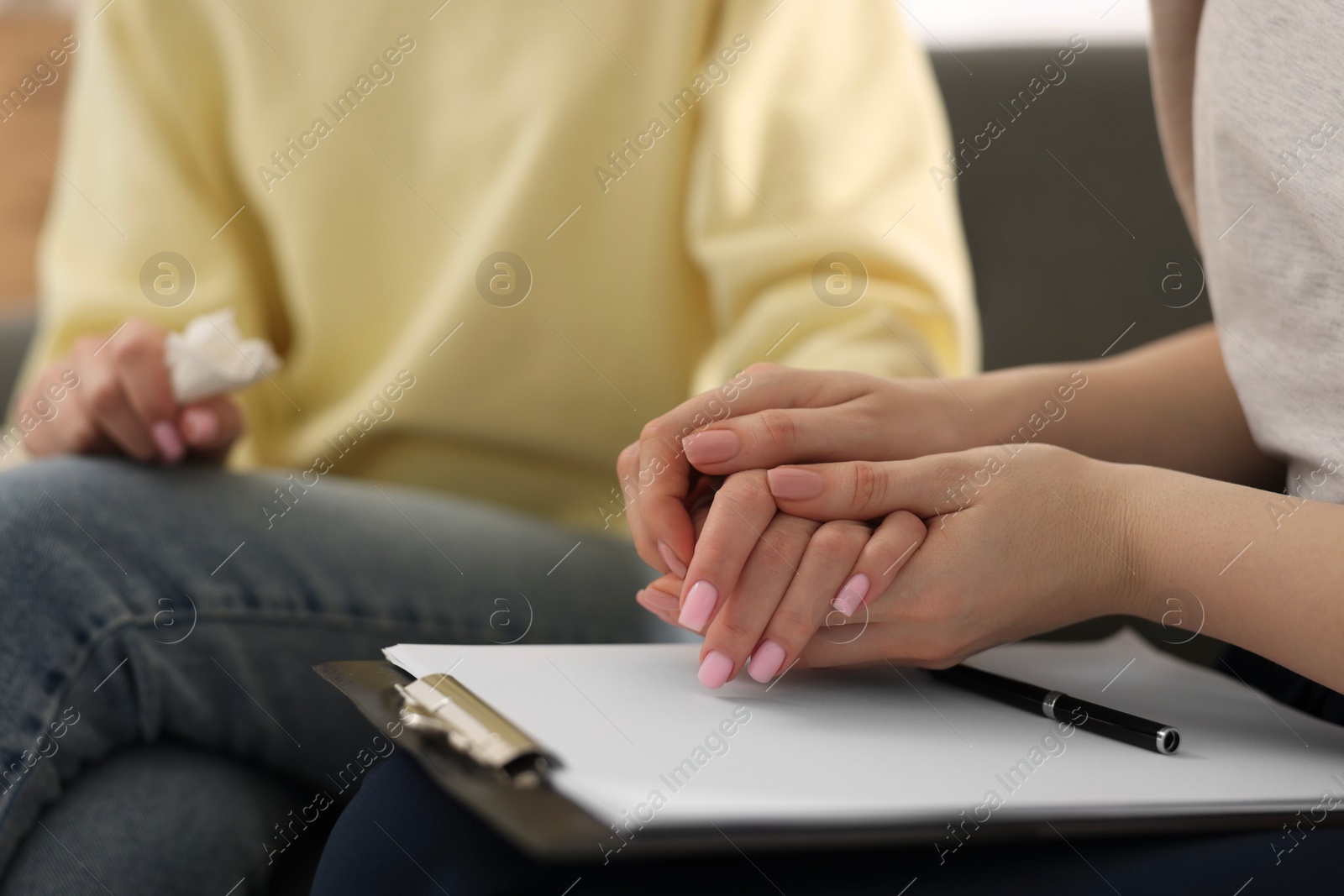 Photo of Professional psychotherapist working with patient in office, closeup