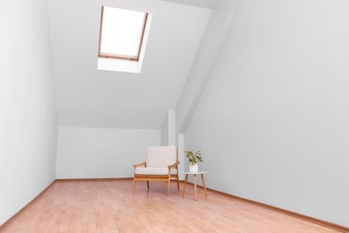 Attic spacious room interior with slanted ceiling and furniture