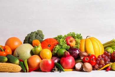 Photo of Assortment of fresh organic fruits and vegetables on light table. Space for text