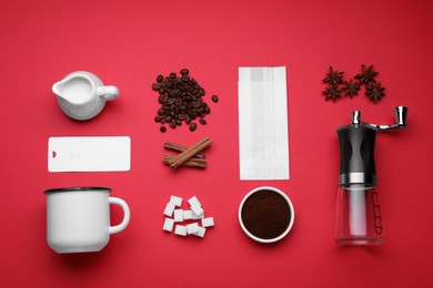 Flat lay composition with manual coffee grinder and spices on red background