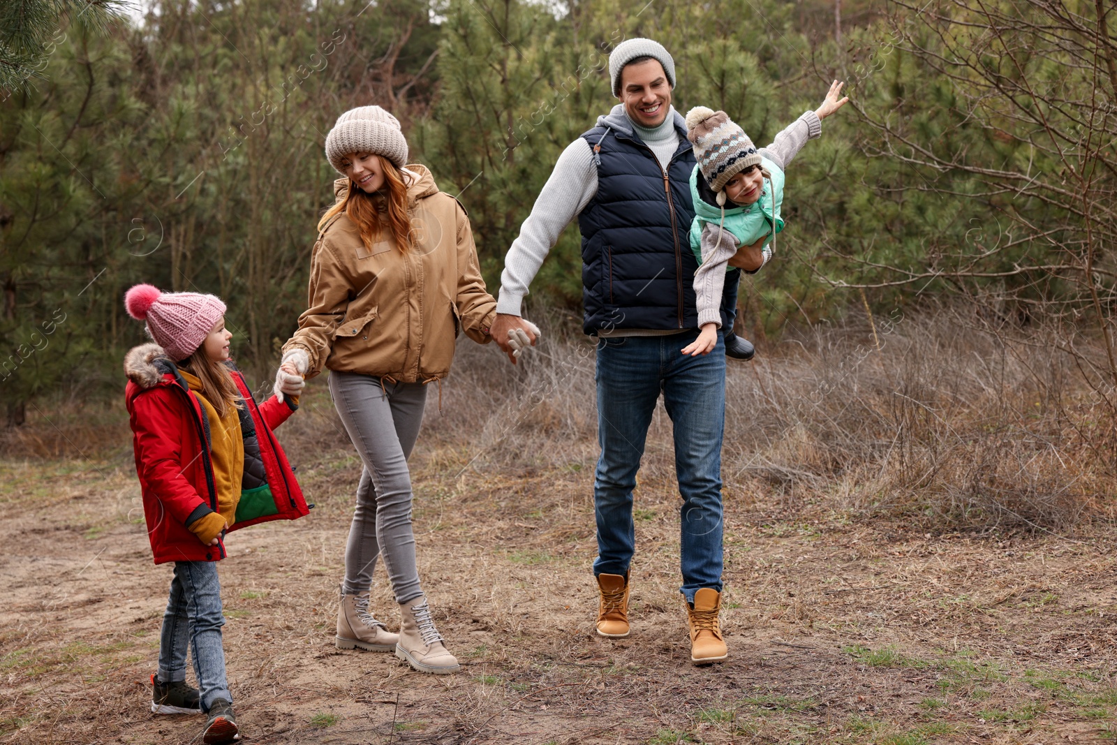 Photo of Happy family spending time together in forest