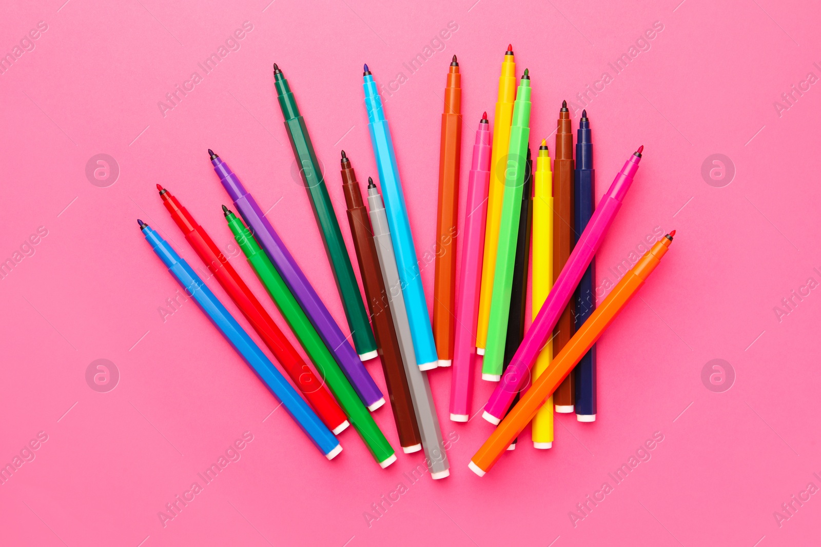 Photo of Many bright markers on pink background, flat lay