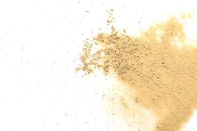 Photo of Pile of brown dust scattered on white background, top view