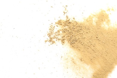 Pile of brown dust scattered on white background, top view