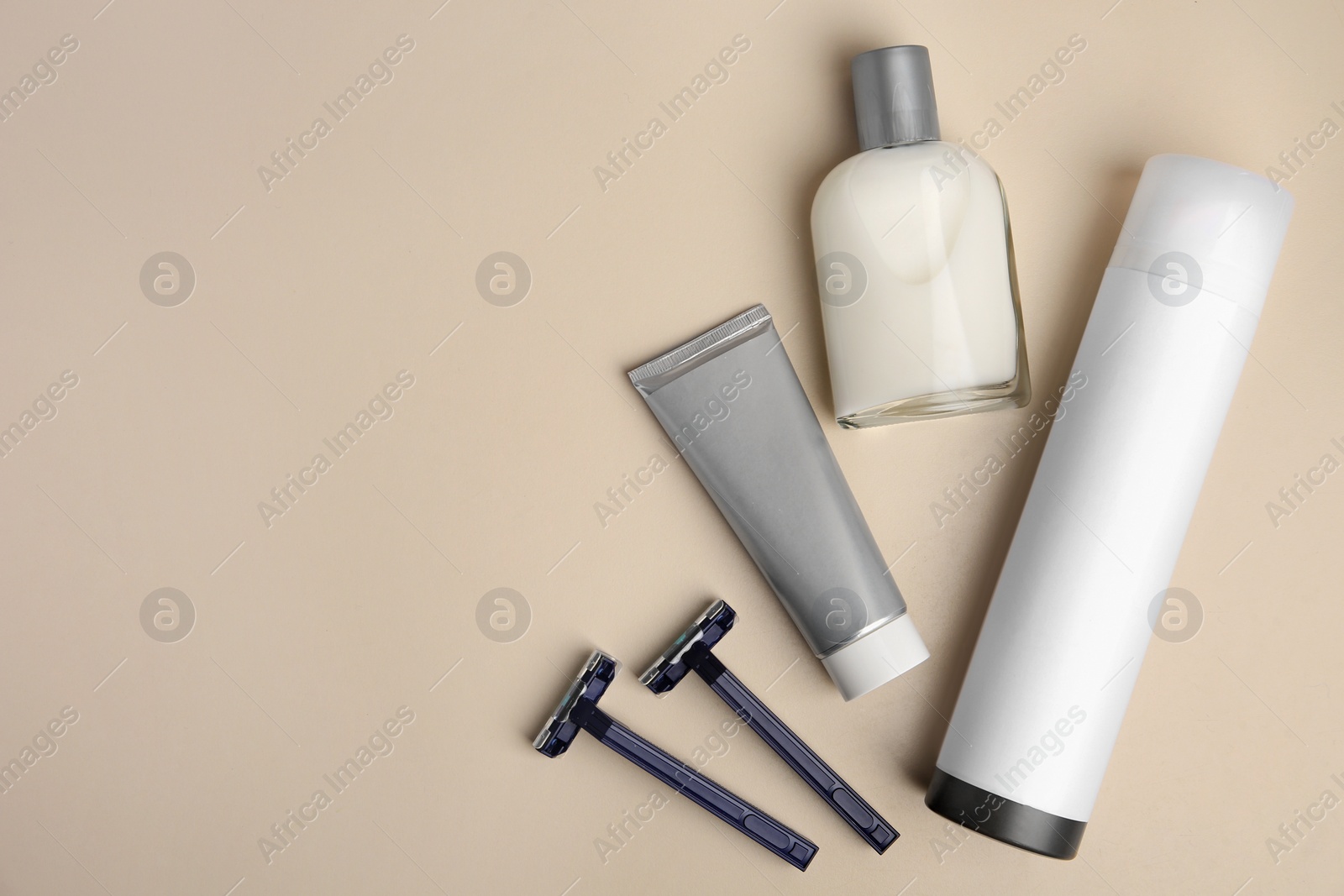 Photo of Flat lay composition with shaving accessories for men on beige background. Space for text