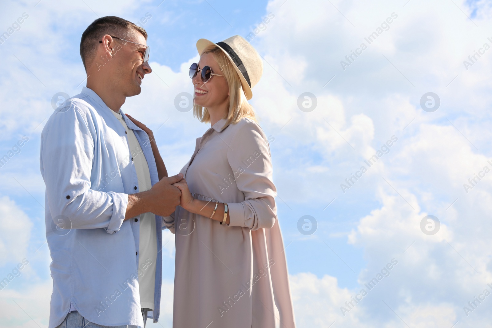 Photo of Happy couple walking outdoors on summer day