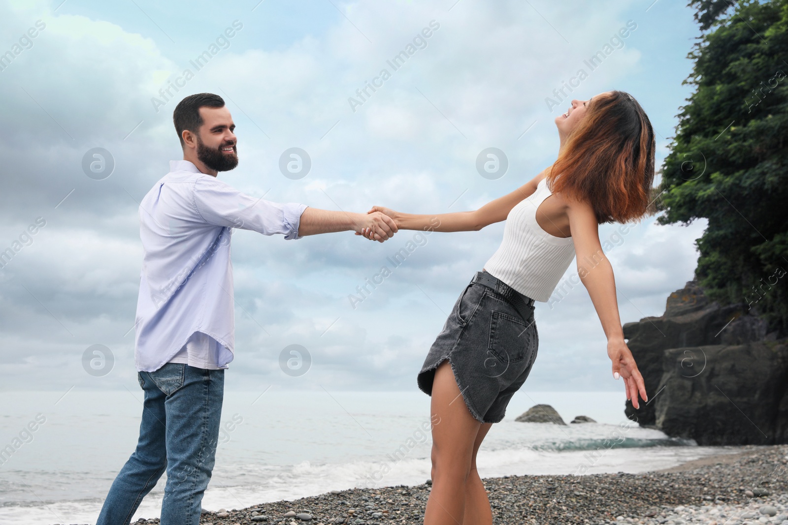 Photo of Happy young couple on beach near sea