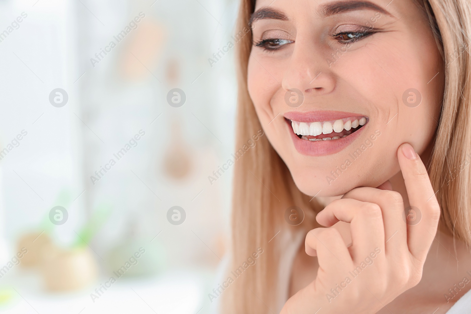 Photo of Young woman with beautiful smile indoors. Teeth whitening