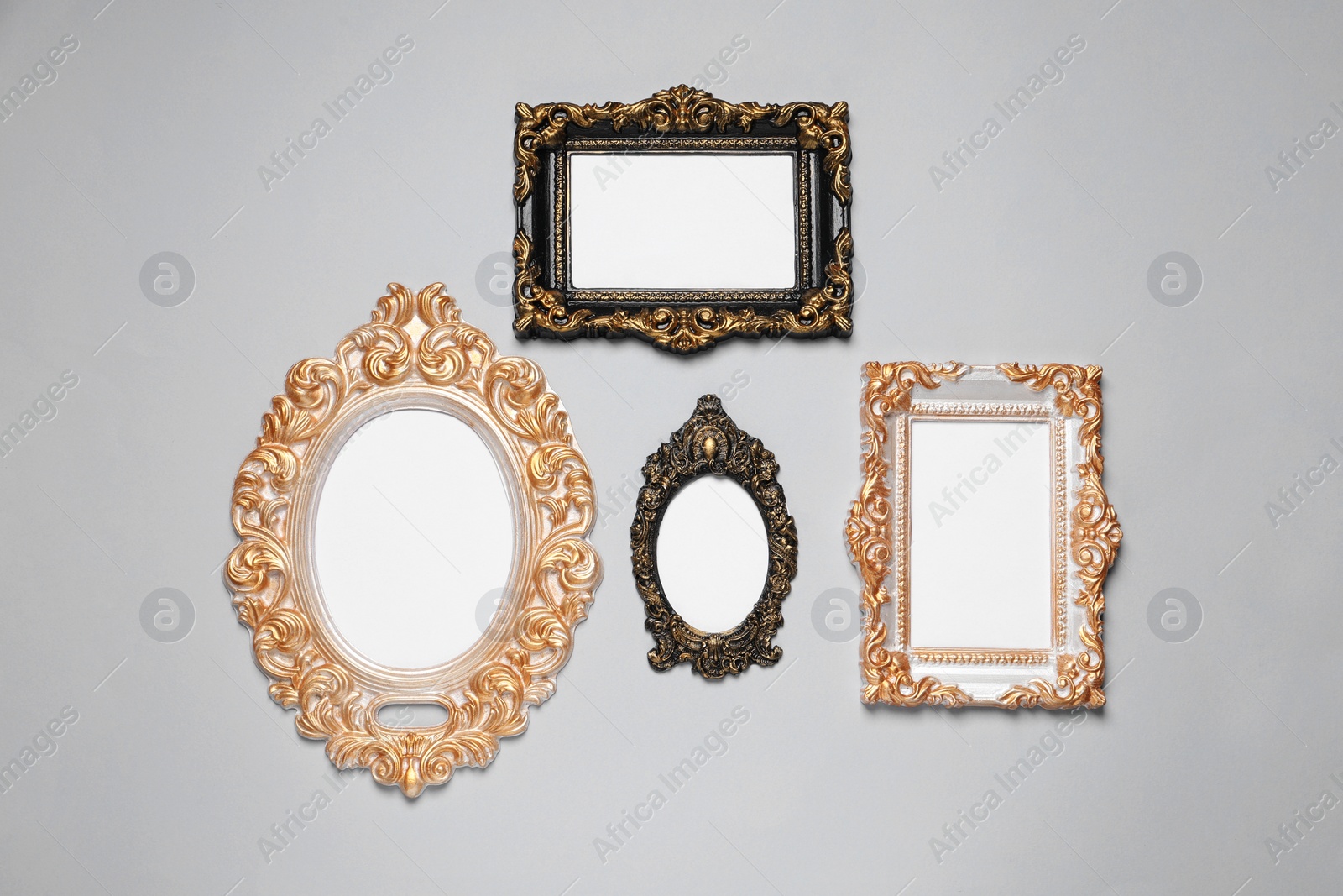 Photo of Empty vintage frames hanging on light gray wall