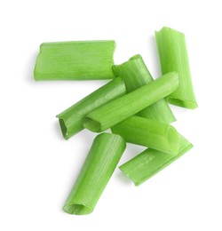 Photo of Pieces of fresh green onion on white background, top view