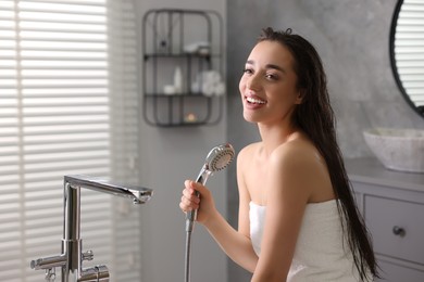 Photo of Happy young woman after shower in bathroom