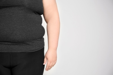 Photo of Overweight woman on light background