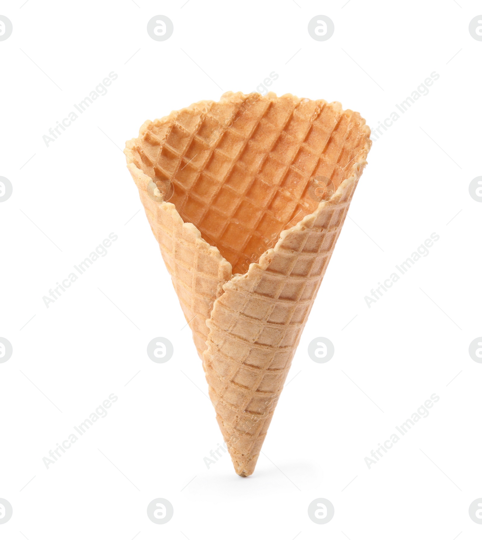 Photo of Empty crispy waffle cone for ice cream on white background