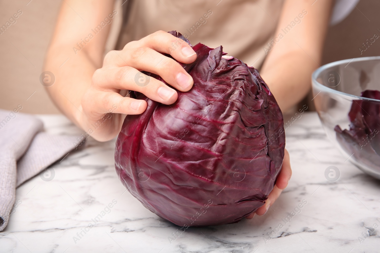 Photo of Woman preparing red cabbage at table