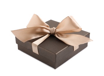 Photo of Dark gift box with golden bow on white background