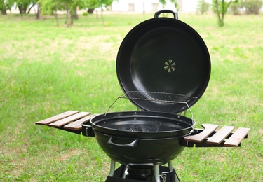 Photo of New modern barbecue grill outdoors. Summer picnic