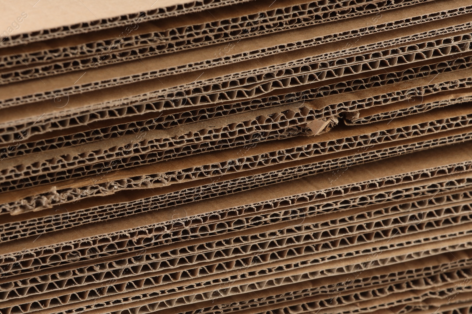 Photo of Sheets of brown corrugated cardboard as background, closeup