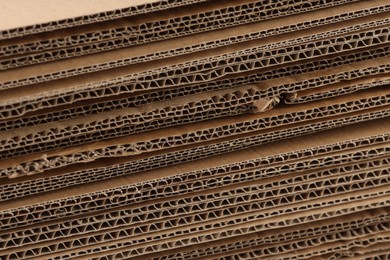 Photo of Sheets of brown corrugated cardboard as background, closeup