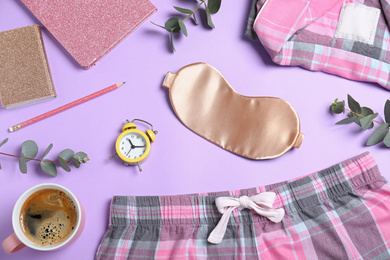 Photo of Flat lay composition with sleeping mask on violet background. Bedtime accessories