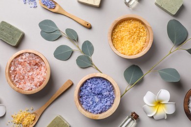 Flat lay composition with spa products and eucalyptus branches on grey background