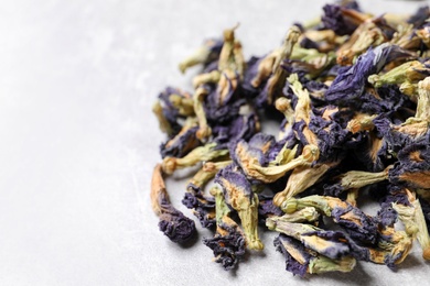 Photo of Pile of dry organic blue Anchan on light table, closeup with space for text. Herbal tea