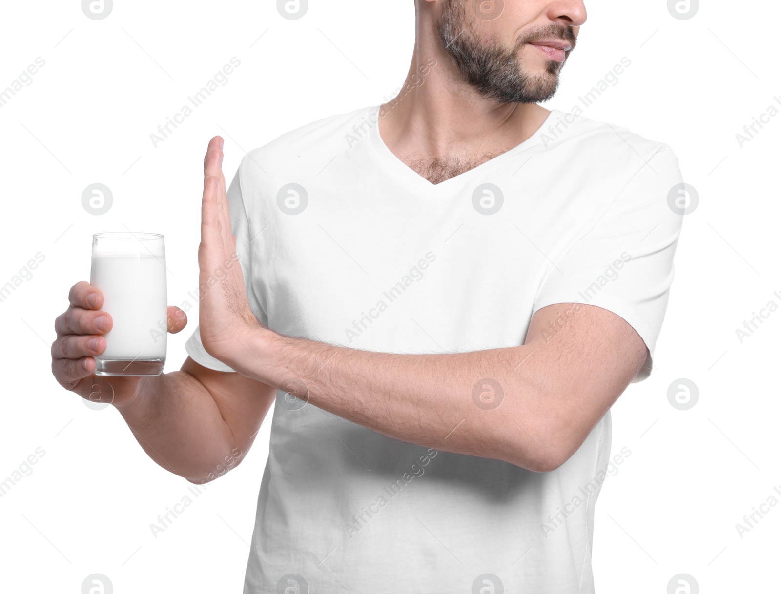 Photo of Man with glass of milk suffering from lactose intolerance on white background, closeup