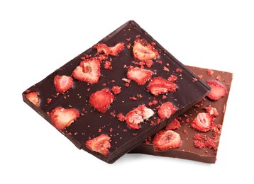 Halves of chocolate bars with freeze dried strawberries on white background