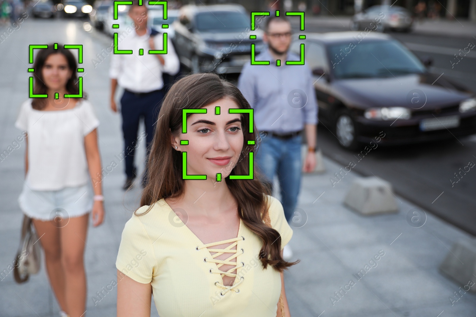 Image of Facial recognition system identifying people on city street 