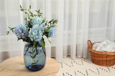 Photo of Beautiful blue hortensia flowers in vase on table indoors. Space for text