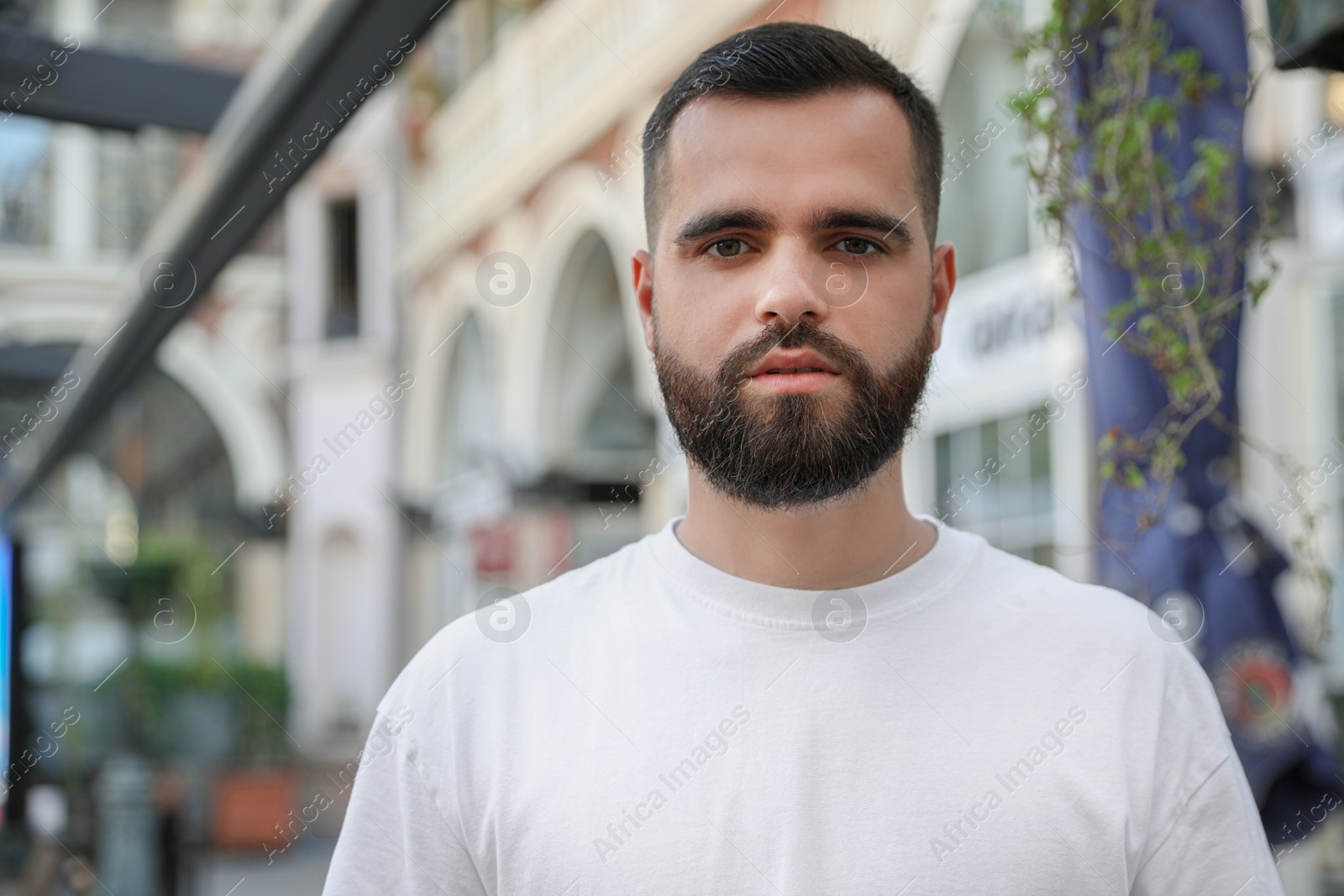 Photo of Portrait of handsome bearded man on city street