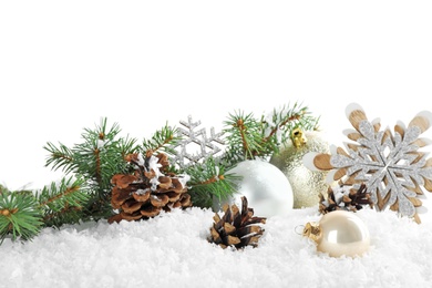 Photo of Christmas decoration on snow against white background